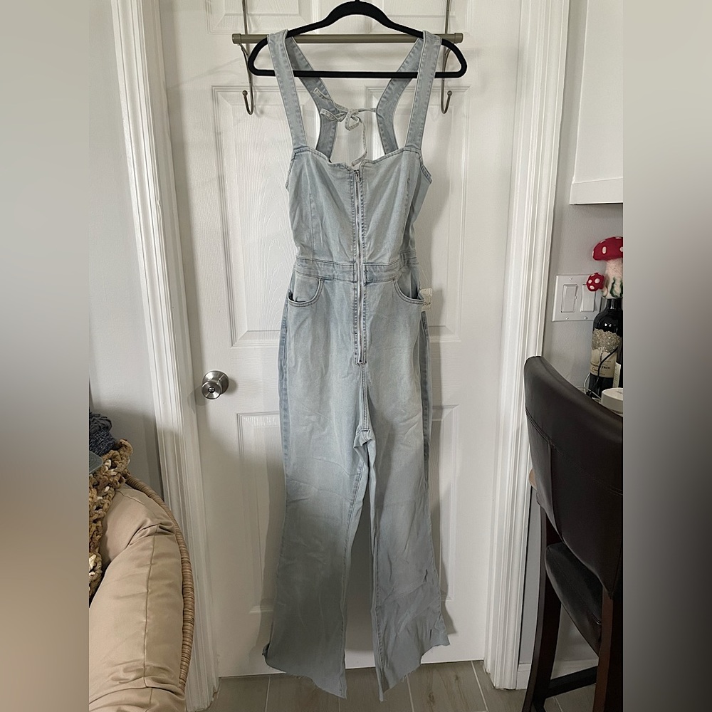 One piece denim jumpsuit. Open back with wide legs. Stretchier denim material.
